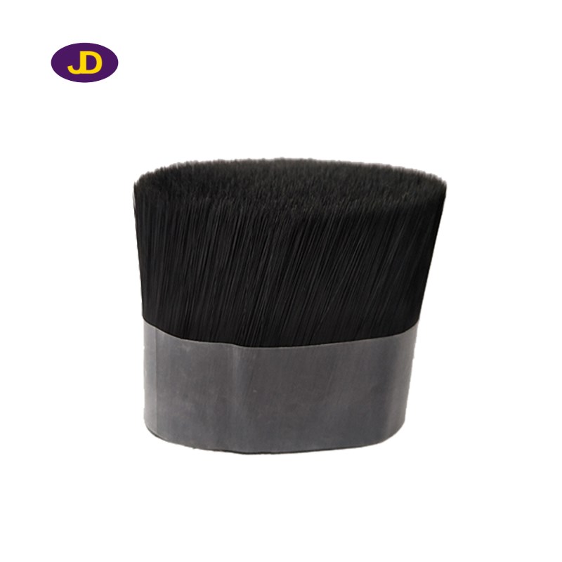 Black solid synthetic brush filaments